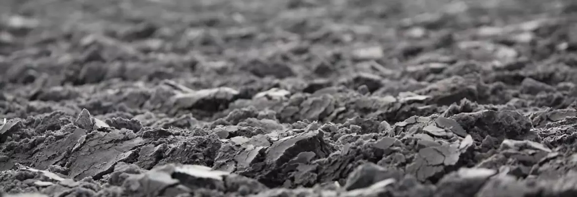 close-up view of a plowed field with rough and uneven soil