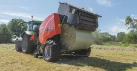 KUHN FB 3135 AUTOMATE ejecting a round bale bound with film.