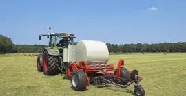 KUHN RW 1410 self-loading round bale wrapper at work