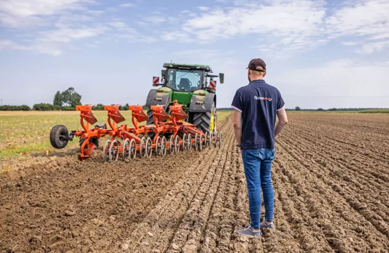 KUHN Plough in a field with a farmer