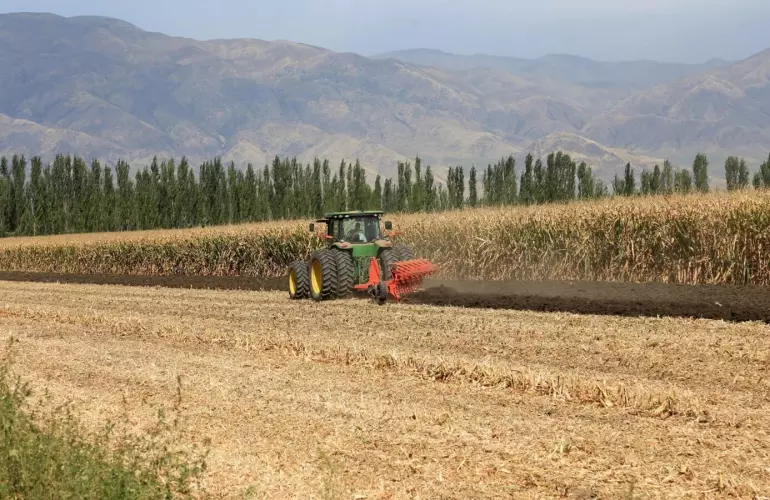 dual wheels tractor ploughing a field