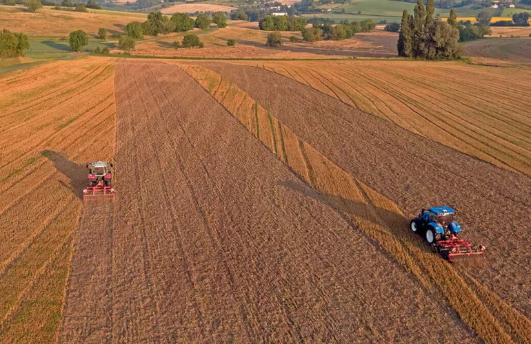 aerial view of stubble cultivators at work in a field