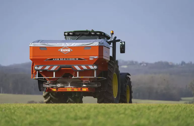 AXIS 40.2 fertiliser spreader in a wheat field
