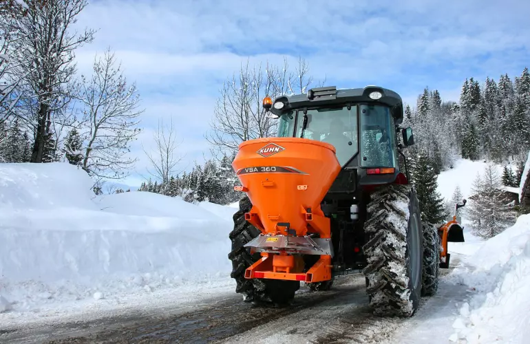 VSA salt and sand spreader at work on mountain roads in the snow