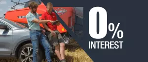 Customer talking to KUHN employee infront of baler in a field