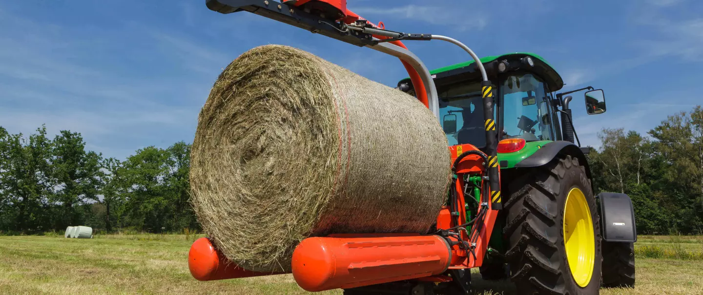 RW 1200 3 point bale wrapper, grabs a bale for wrapping.