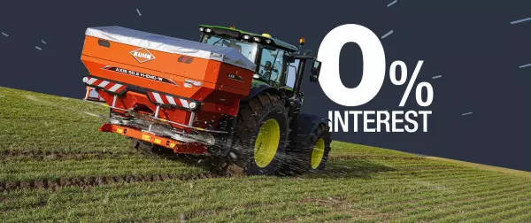 Fertiliser spreader in a green field