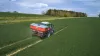 AXIS 50.2 fertiliser spreader at work in a wheat field