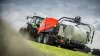 FBP 3135 wrapping a bale under a cloudy sky